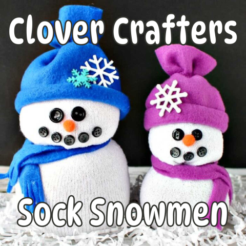 Two sock snowmen make up the majority of the screen, one with a blue hat and scarf and one with a purple hat and scarf. White bubble style font reads clover crafters, sock snowmen.