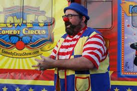 Man dressed as a colorful clown.