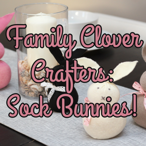 Cute bunnies made out of socks and rice sit on a table. The bunnies are chubby, and are black and off white. A candle sits next to them. Text reads Family Clover Crafters: Sock Bunnies!